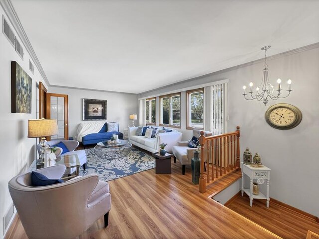 2919 193rd St, Lansing, IL 60438 - living room featuring a chandelier, wood finished floors, crown molding, and baseboards
