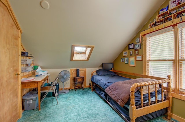 bedroom with multiple windows, carpet, vaulted ceiling, and a skylight