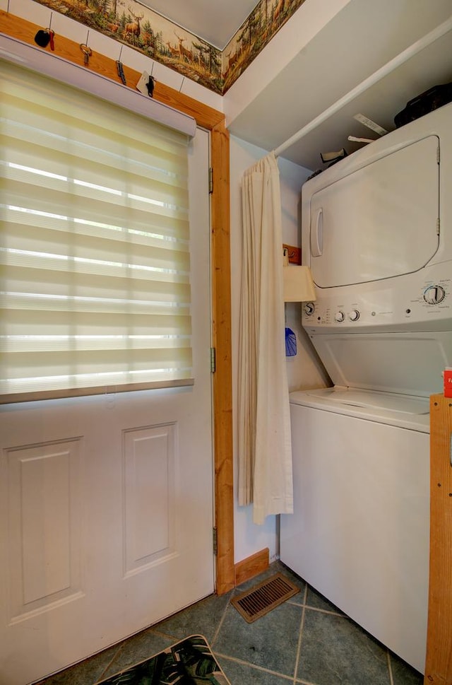 laundry area with stacked washing machine and dryer