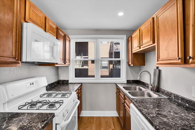 2907 W Summerdale Ave Unit D2, Chicago, IL 60625 - kitchen featuring white appliances, a sink, light wood-style floors, brown cabinetry, and baseboards