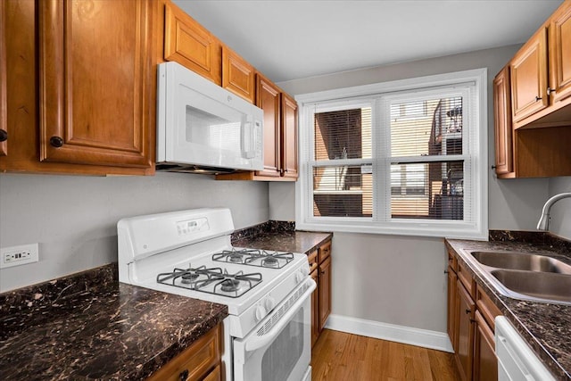2907 W Summerdale Ave Unit D2, Chicago, IL 60625 - kitchen with white appliances, a sink, light wood finished floors, baseboards, and brown cabinetry
