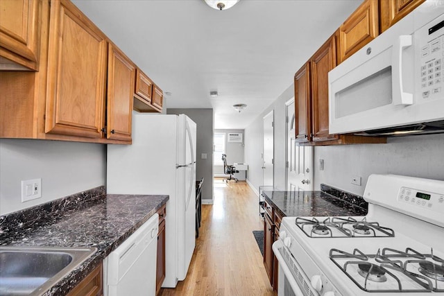 2907 W Summerdale Ave Unit D2, Chicago, IL 60625 - kitchen featuring white appliances, brown cabinets, light wood-style flooring, and dark stone countertops