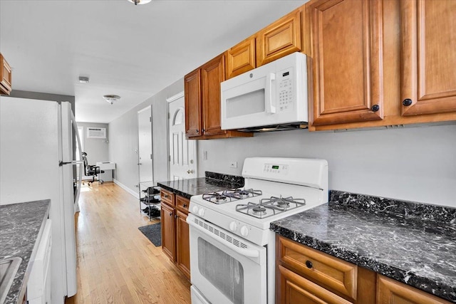 2907 W Summerdale Ave Unit D2, Chicago, IL 60625 - kitchen with white appliances, light wood finished floors, brown cabinetry, and dark stone countertops