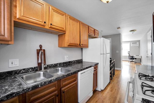2907 W Summerdale Ave Unit D2, Chicago, IL 60625 - kitchen with white appliances, a sink, light wood-style floors, an AC wall unit, and brown cabinetry