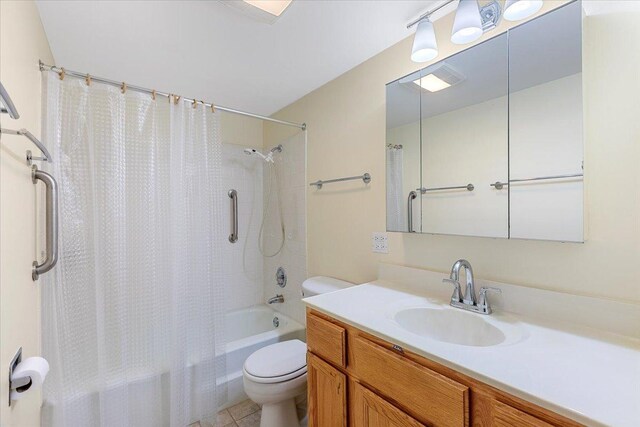 full bathroom with toilet, shower / bath combo with shower curtain, vanity, and tile patterned floors