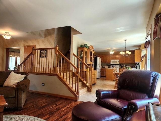 19629 Fiona Ave, Mokena, IL 60448 - living room with a chandelier, stairs, light wood-type flooring, and baseboards