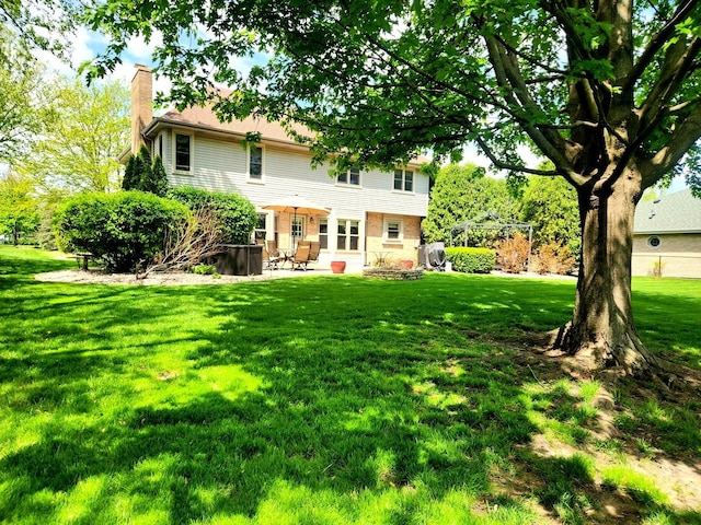 19629 Fiona Ave, Mokena, IL 60448 - rear view of property featuring a chimney, a yard, and a patio