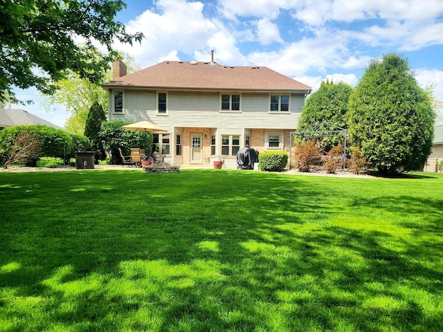 19629 Fiona Ave, Mokena, IL 60448 - back of house with a chimney, a yard, and a patio area