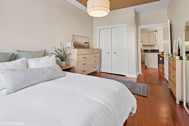 bedroom with a closet and dark wood-style floors