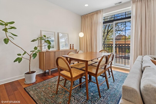 dining area with baseboards, wood finished floors, and recessed lighting