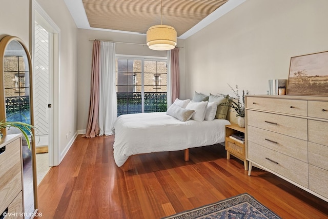 bedroom featuring wood finished floors and baseboards