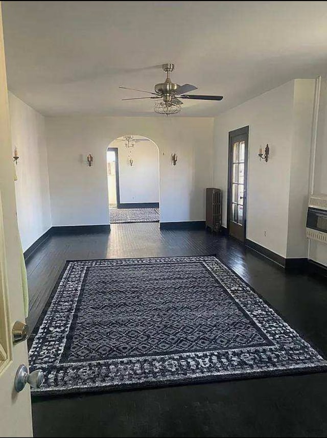 720 S Carroll Ave, Freeport, IL 61032 - foyer featuring arched walkways, baseboards, ceiling fan, and heating unit