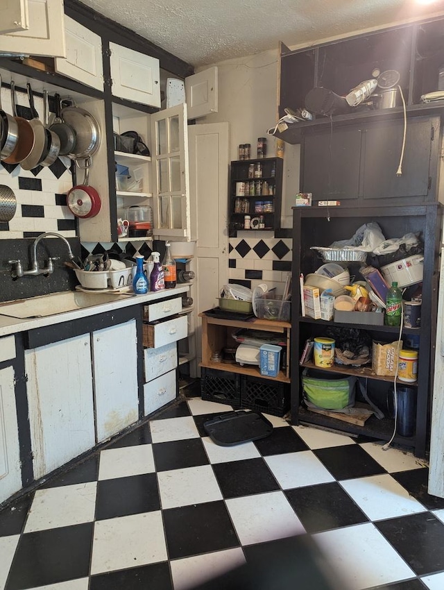 720 S Carroll Ave, Freeport, IL 61032 - kitchen featuring tile patterned floors, a sink, open shelves, light countertops, and glass insert cabinets
