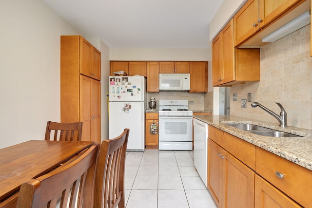 35 Buckingham Ln, Buffalo Grove, IL 60089 - kitchen with white appliances, a sink, decorative backsplash, light tile patterned flooring, and light stone counters