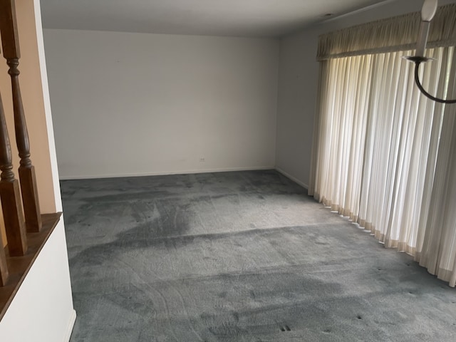carpeted spare room with baseboards
