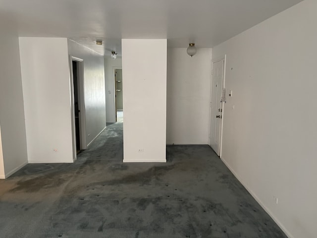 carpeted empty room with baseboards