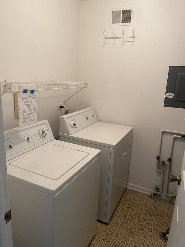 clothes washing area featuring washing machine and clothes dryer and baseboards