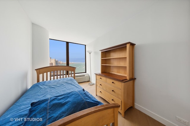 bedroom with light wood-type flooring and baseboards