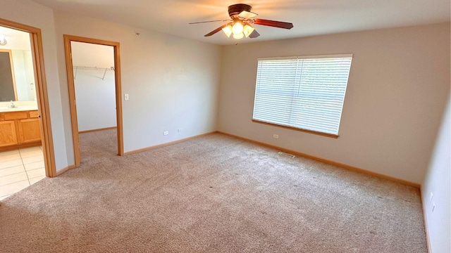 6409 Old Plank Blvd, Matteson, IL 60443 - unfurnished bedroom with light colored carpet, a spacious closet, a closet, baseboards, and ensuite bath