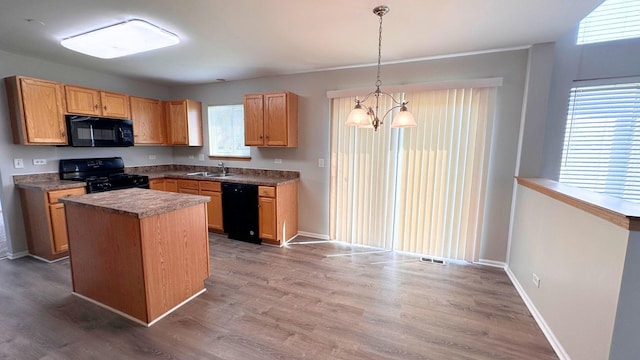 6409 Old Plank Blvd, Matteson, IL 60443 - kitchen with black appliances, a sink, a chandelier, and wood finished floors