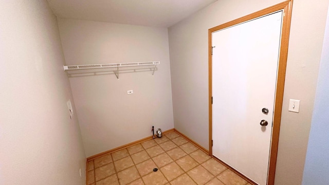 6409 Old Plank Blvd, Matteson, IL 60443 - clothes washing area with baseboards and light tile patterned floors