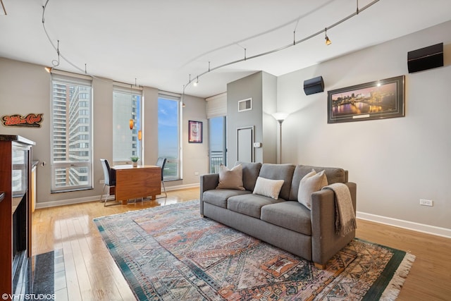 1250 S Michigan Ave Unit 2203, Chicago, IL 60605 - living area featuring track lighting, wood finished floors, and baseboards