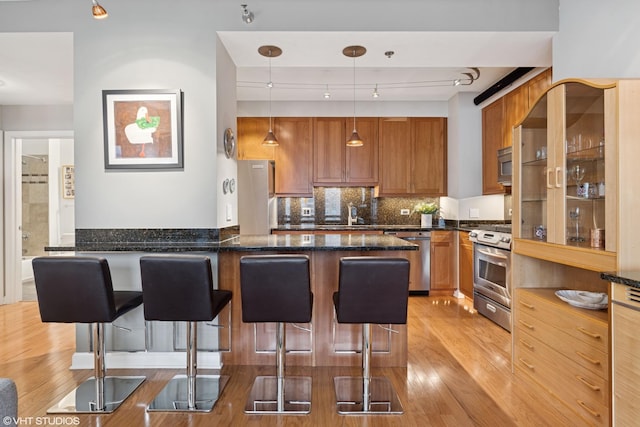 1250 S Michigan Ave Unit 2203, Chicago, IL 60605 - kitchen with appliances with stainless steel finishes, light wood-type flooring, a kitchen bar, and a sink