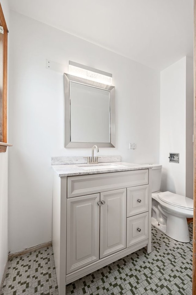 bathroom featuring tile patterned floors, vanity, and toilet