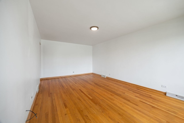 unfurnished room featuring light wood finished floors and baseboards