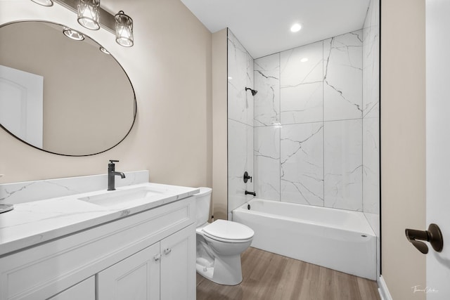 full bathroom with wood finished floors, toilet, vanity, bathing tub / shower combination, and recessed lighting