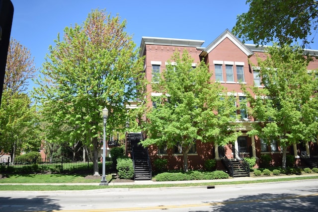 133 S Grove Ave, Elgin, IL 60120 - view of front of home with stairway, fence, and brick siding