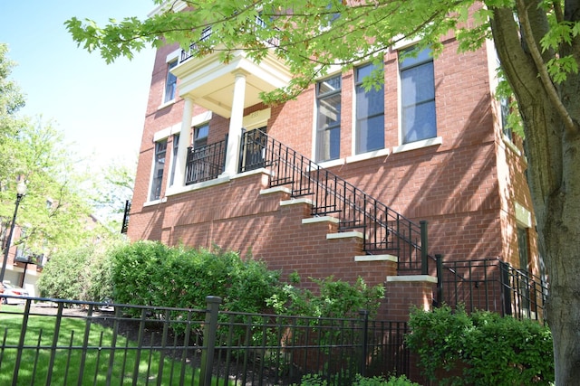 133 S Grove Ave, Elgin, IL 60120 - view of side of home with brick siding, fence, and stairs