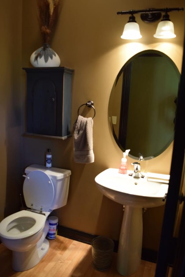 133 S Grove Ave, Elgin, IL 60120 - bathroom with toilet, wood finished floors, and baseboards