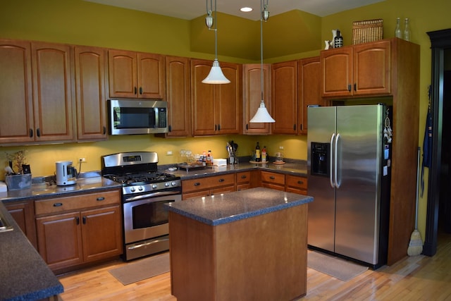 133 S Grove Ave, Elgin, IL 60120 - kitchen with appliances with stainless steel finishes, light wood finished floors, a center island, and pendant lighting