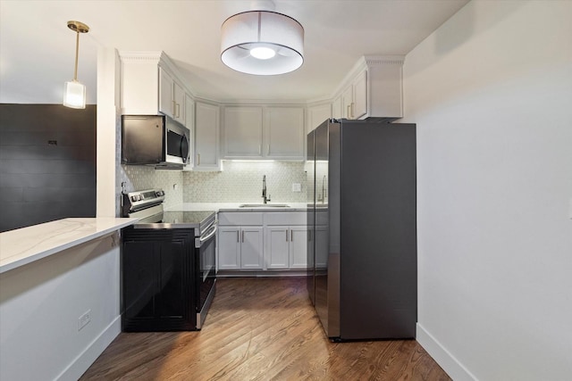 2334 N Harlem Ave Unit 3C, Elmwood Park, IL 60707 - kitchen with appliances with stainless steel finishes, a sink, dark wood-style flooring, decorative backsplash, and white cabinetry