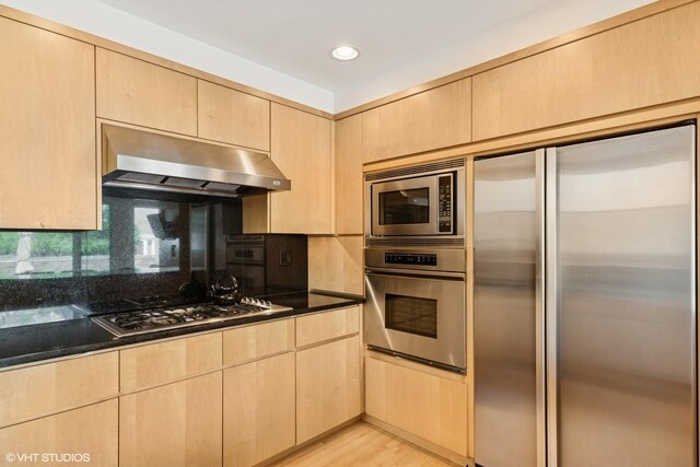 58 W Schiller St, Chicago, IL 60610 - kitchen with built in appliances, exhaust hood, light brown cabinets, backsplash, and recessed lighting