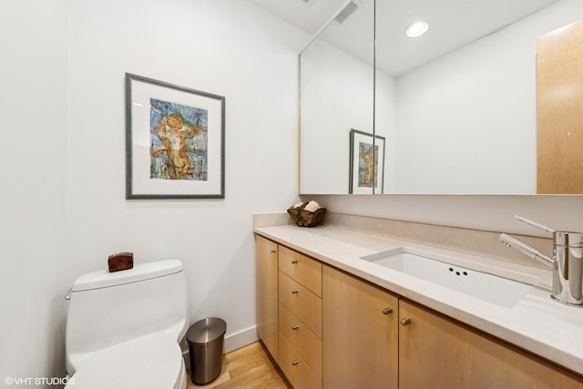 58 W Schiller St, Chicago, IL 60610 - bathroom featuring vanity, baseboards, toilet, wood finished floors, and recessed lighting