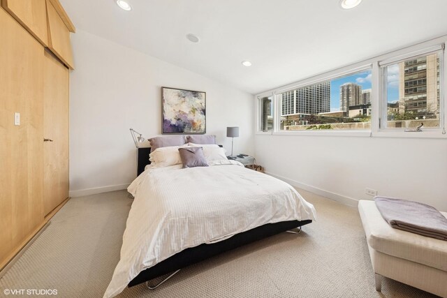 58 W Schiller St, Chicago, IL 60610 - bedroom featuring light colored carpet, baseboards, recessed lighting, a view of city, and vaulted ceiling
