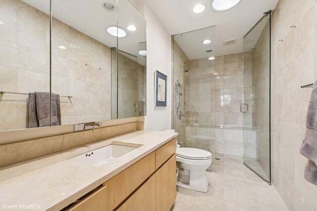 58 W Schiller St, Chicago, IL 60610 - full bath with tile walls, a shower stall, toilet, vanity, and recessed lighting