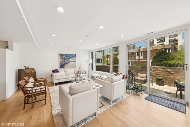 58 W Schiller St, Chicago, IL 60610 - living room with plenty of natural light, light wood-style floors, recessed lighting, and baseboards