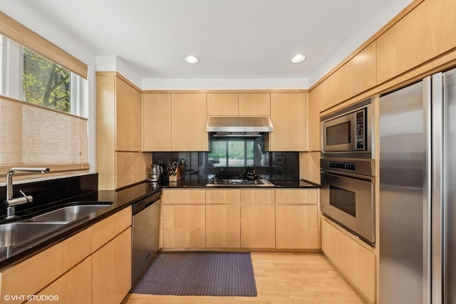 58 W Schiller St, Chicago, IL 60610 - kitchen featuring stainless steel appliances, light brown cabinetry, under cabinet range hood, dark countertops, and recessed lighting