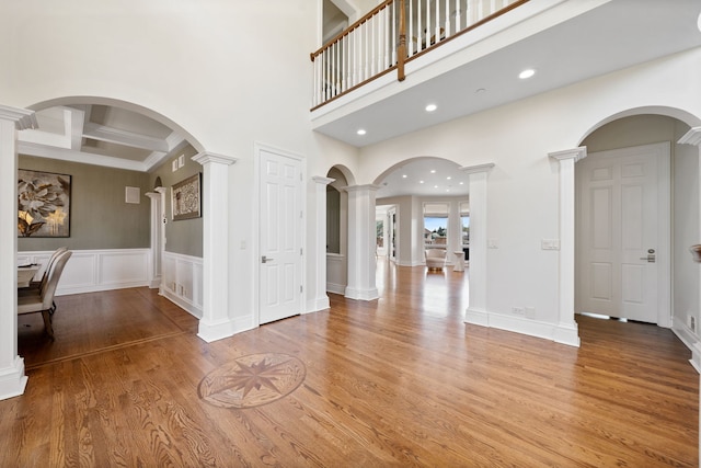 6590 Beech Ln, Libertyville, IL 60048 - entryway with decorative columns, light wood finished floors, beam ceiling, a wainscoted wall, and recessed lighting