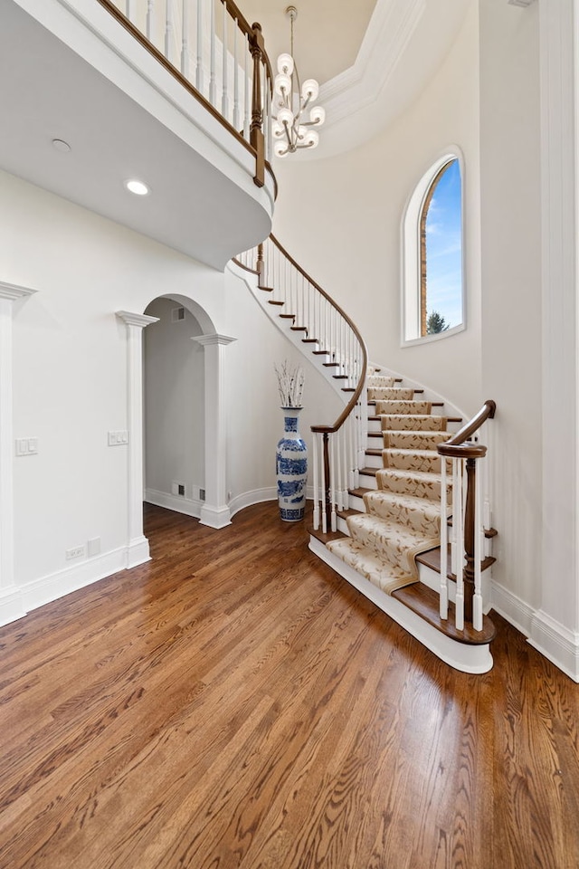 6590 Beech Ln, Libertyville, IL 60048 - entrance foyer with wood finished floors, stairs, arched walkways, baseboards, and ornamental molding