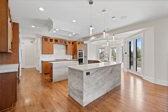 6590 Beech Ln, Libertyville, IL 60048 - kitchen featuring a large island, a sink, stainless steel double oven, recessed lighting, and brown cabinetry