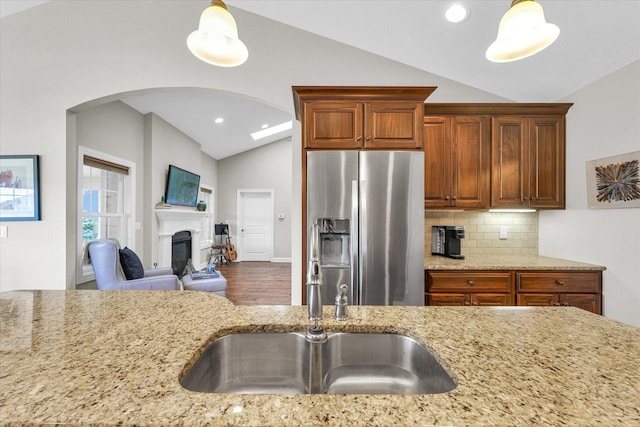 1601 Congressional Way, Champaign, IL 61822 - kitchen featuring vaulted ceiling, stainless steel refrigerator with ice dispenser, a sink, arched walkways, and light stone countertops