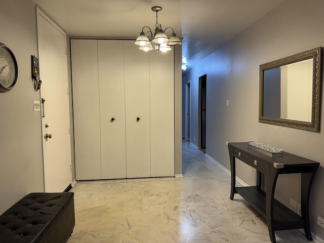 7033 N Kedzie Ave Unit 904, Chicago, IL 60645 - hallway with light marble finish floors, a chandelier, and baseboards