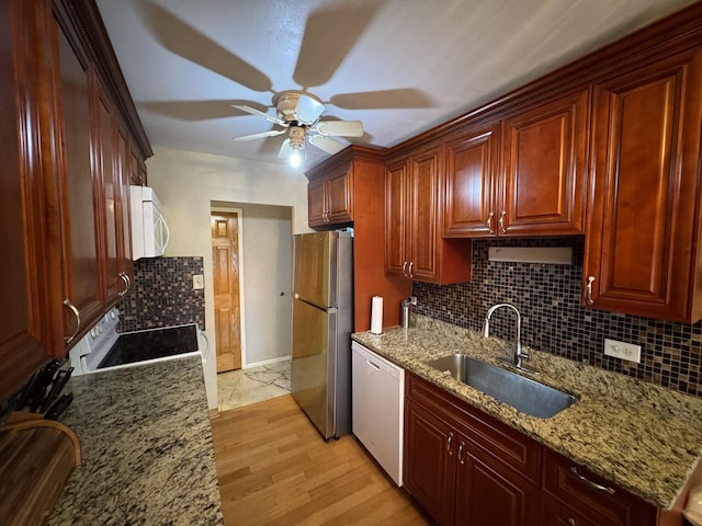7033 N Kedzie Ave Unit 904, Chicago, IL 60645 - kitchen with white appliances, a sink, ceiling fan, decorative backsplash, and light stone countertops