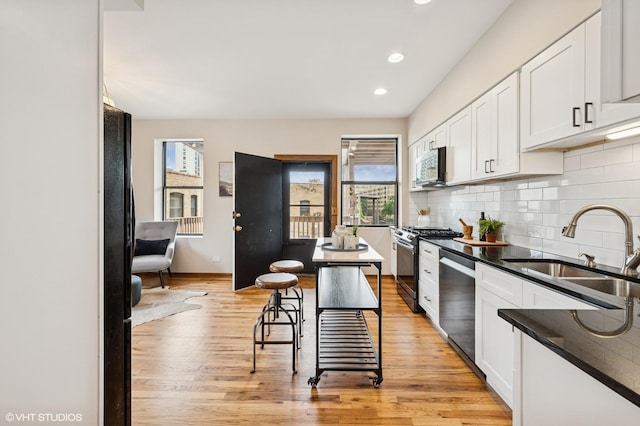 5055 N Sheridan Rd Unit 3N, Chicago, IL 60640 - kitchen with stainless steel appliances, plenty of natural light, white cabinetry, backsplash, and recessed lighting