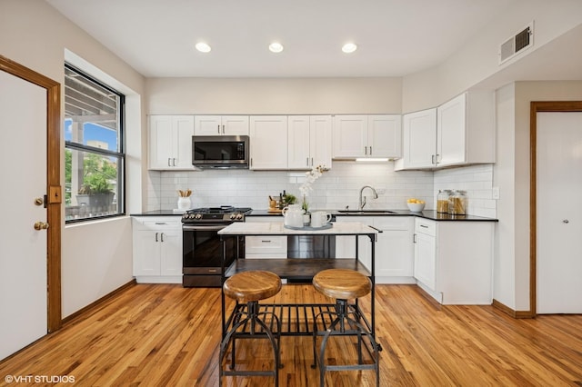 5055 N Sheridan Rd Unit 3N, Chicago, IL 60640 - kitchen with appliances with stainless steel finishes, light wood-style floors, white cabinets, and recessed lighting