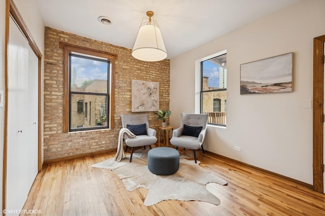 5055 N Sheridan Rd Unit 3N, Chicago, IL 60640 - living area with brick wall and wood finished floors
